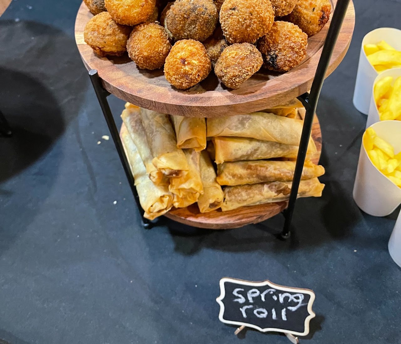 Tiered stand of spring rolls and croquettes at a TML catered event