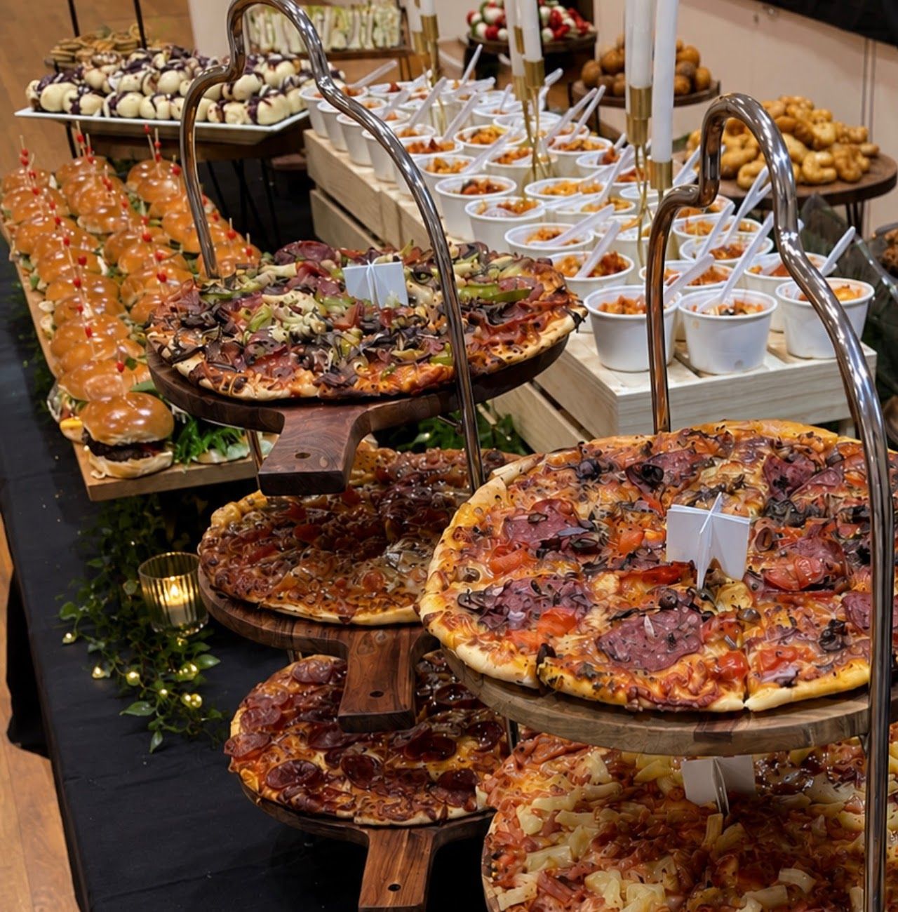 Main catering table with woodfired pizzas, sliders and pasta cups
