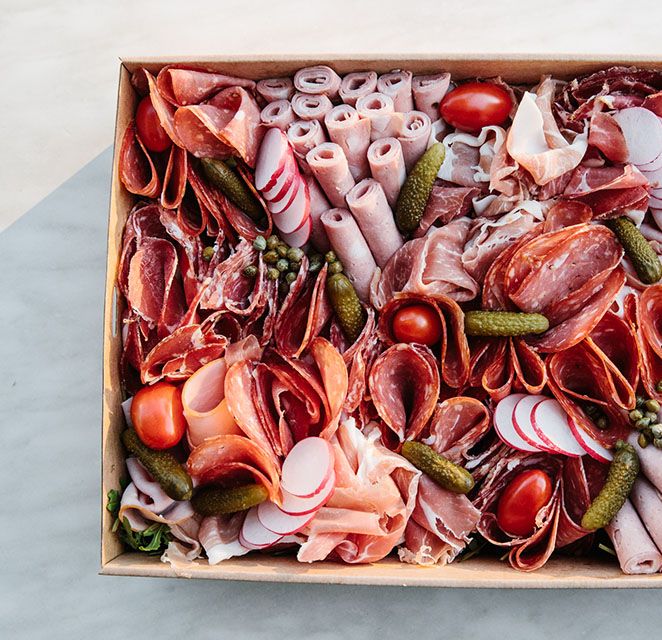 Antipasto box of cured meats, pickles and fresh vegetables